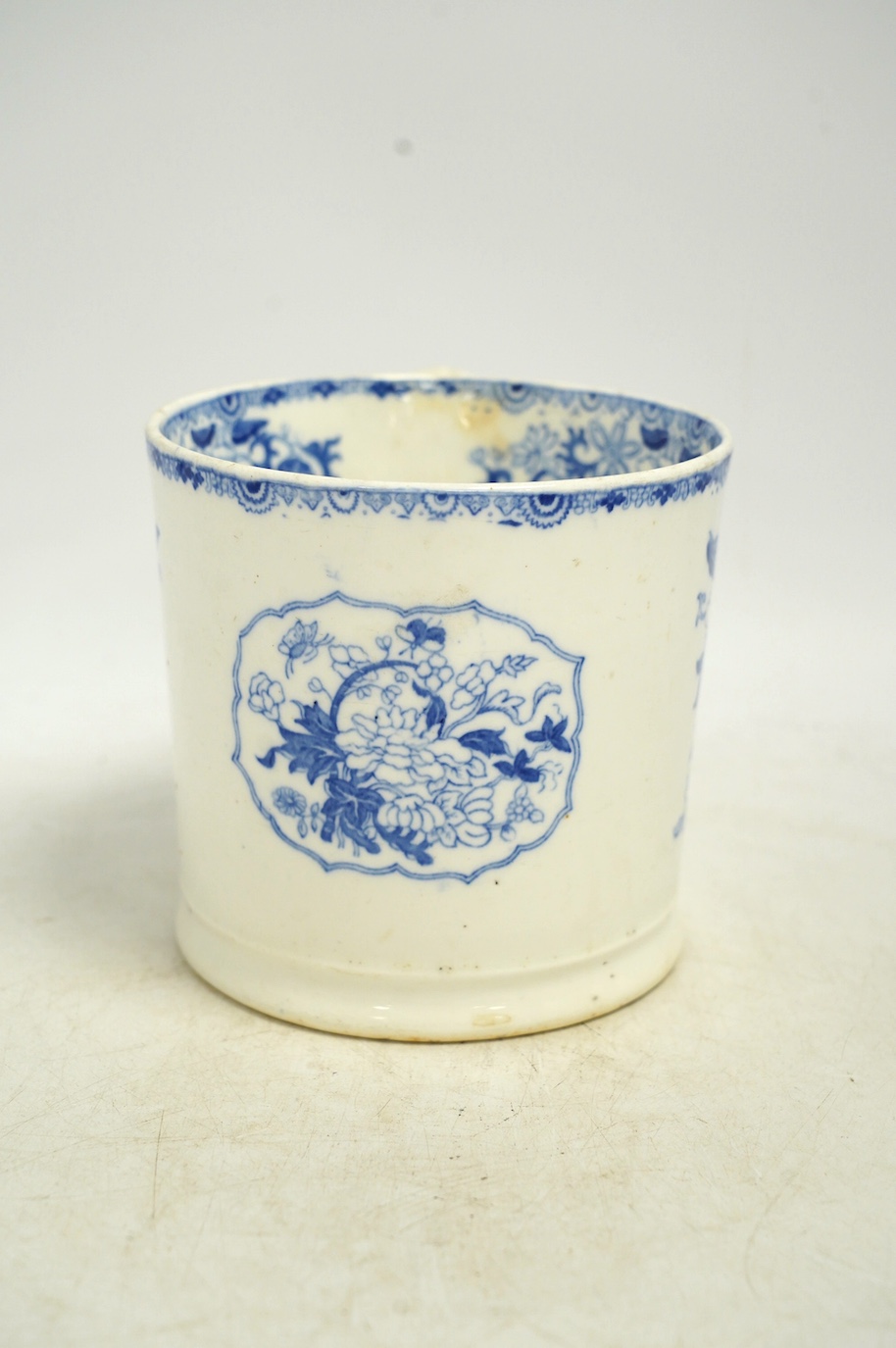 An early Victorian blue and white bone china mug, 13cm high. Condition - fair, crack to the handle